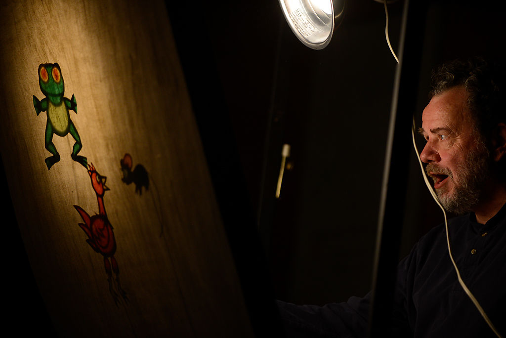 Puppeteer Peter Allen performs "The Little Red Hen" with shadow puppets